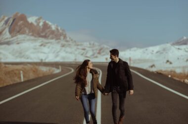 man and woman walking on road