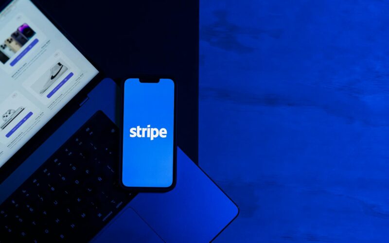 laptop and smartphone with stripe app displayed