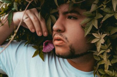 contemplative man amidst lush greenery