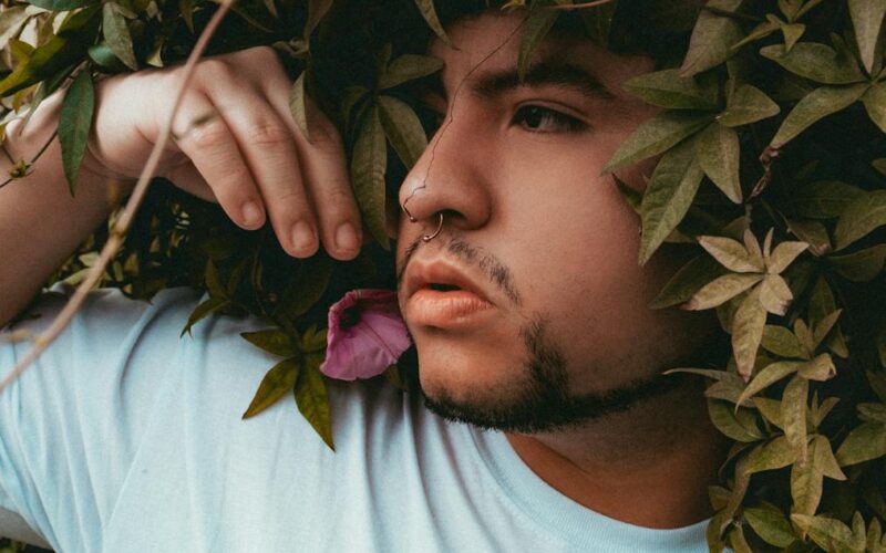 contemplative man amidst lush greenery