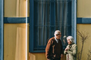 man and woman standing in front of building s window