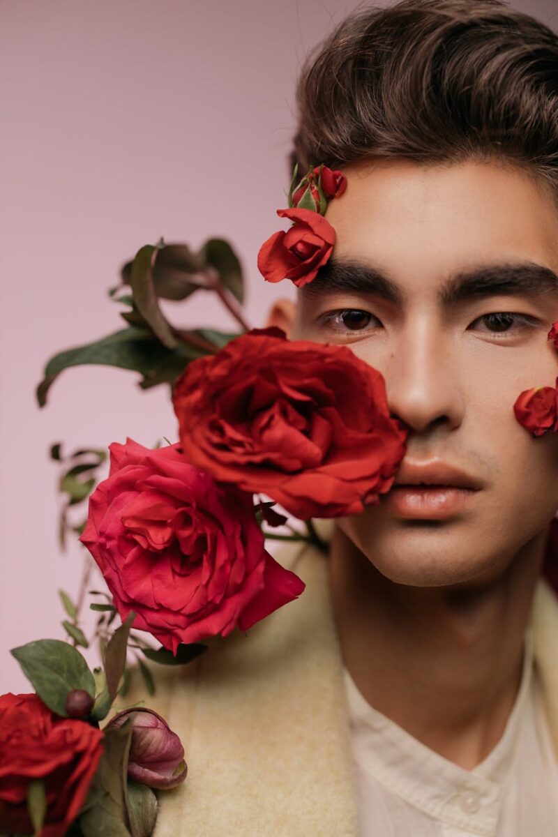 portrait of a handsome man with red roses