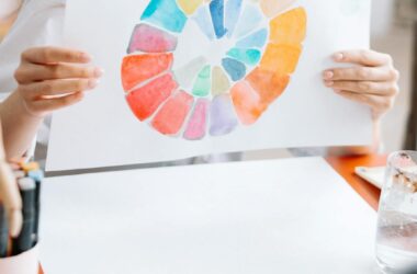 a woman holding white paper with rainbow color