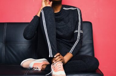 woman sitting on sofa bed wearing sunglasses