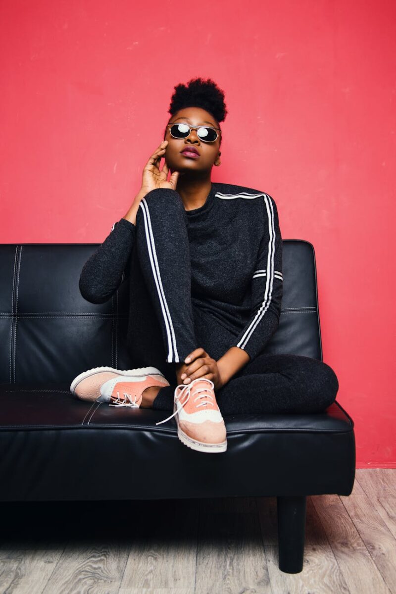 woman sitting on sofa bed wearing sunglasses